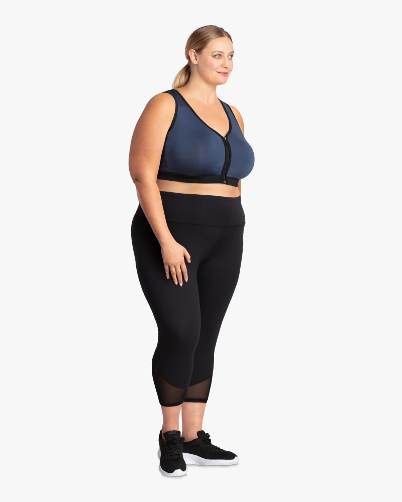 Plus size model with hourglass body shape wearing Como Zip Front Sports Bra by Rainbeau Curves | Dia&Co | dia_product_style_image_id:114927